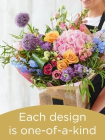 Hand tied bouquet made with seasonal flowers.